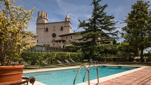 A swimming pool with a view of a historic building in the background.
