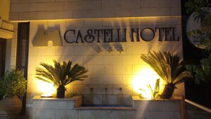 A hotel sign with the name "CASTELLI HOTEL" illuminated against a wall. - Castelli Hotel (Nicosia)