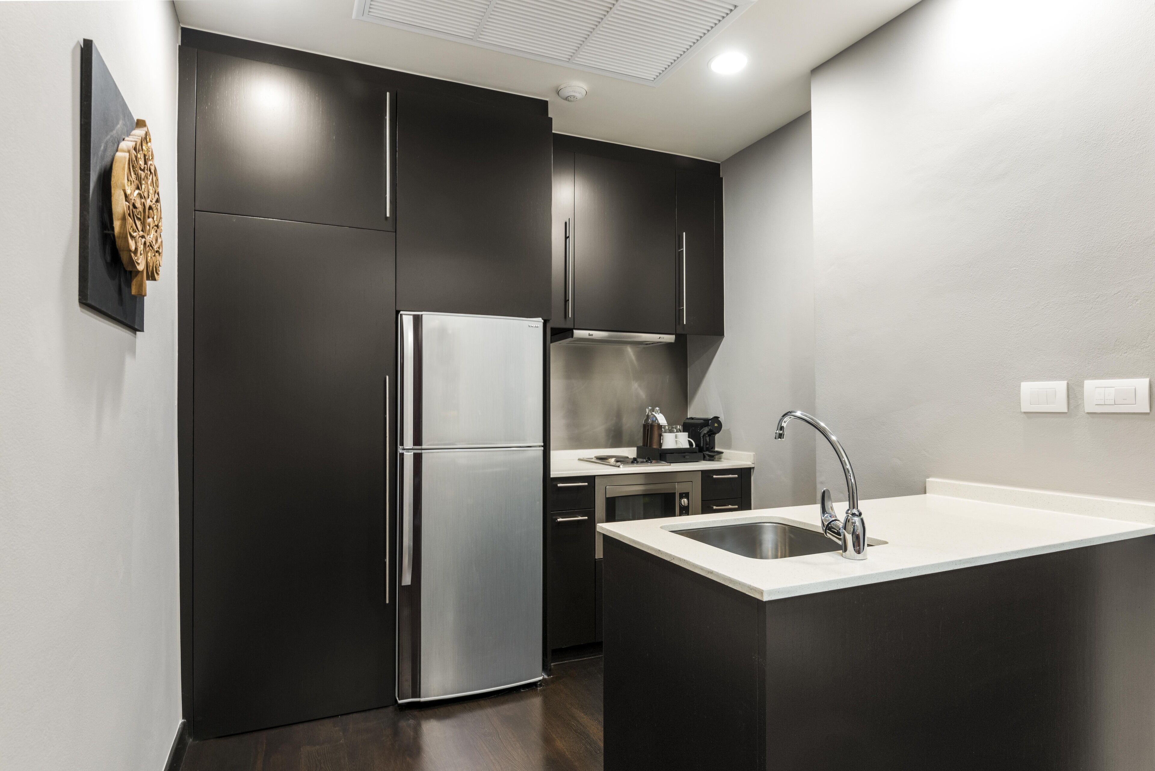 fridge, coffee/tea maker, electric kettle, cookware/dishes/utensils