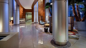 A spacious lobby with high ceilings, polished marble floors, and modern furnishings. - Bay Lake Tower at Disney's Contemporary Resort (Lake Buena Vista)