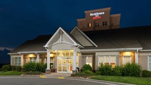 A hotel with a prominent sign reading "Residence Inn Marriott" and a well-lit entrance.