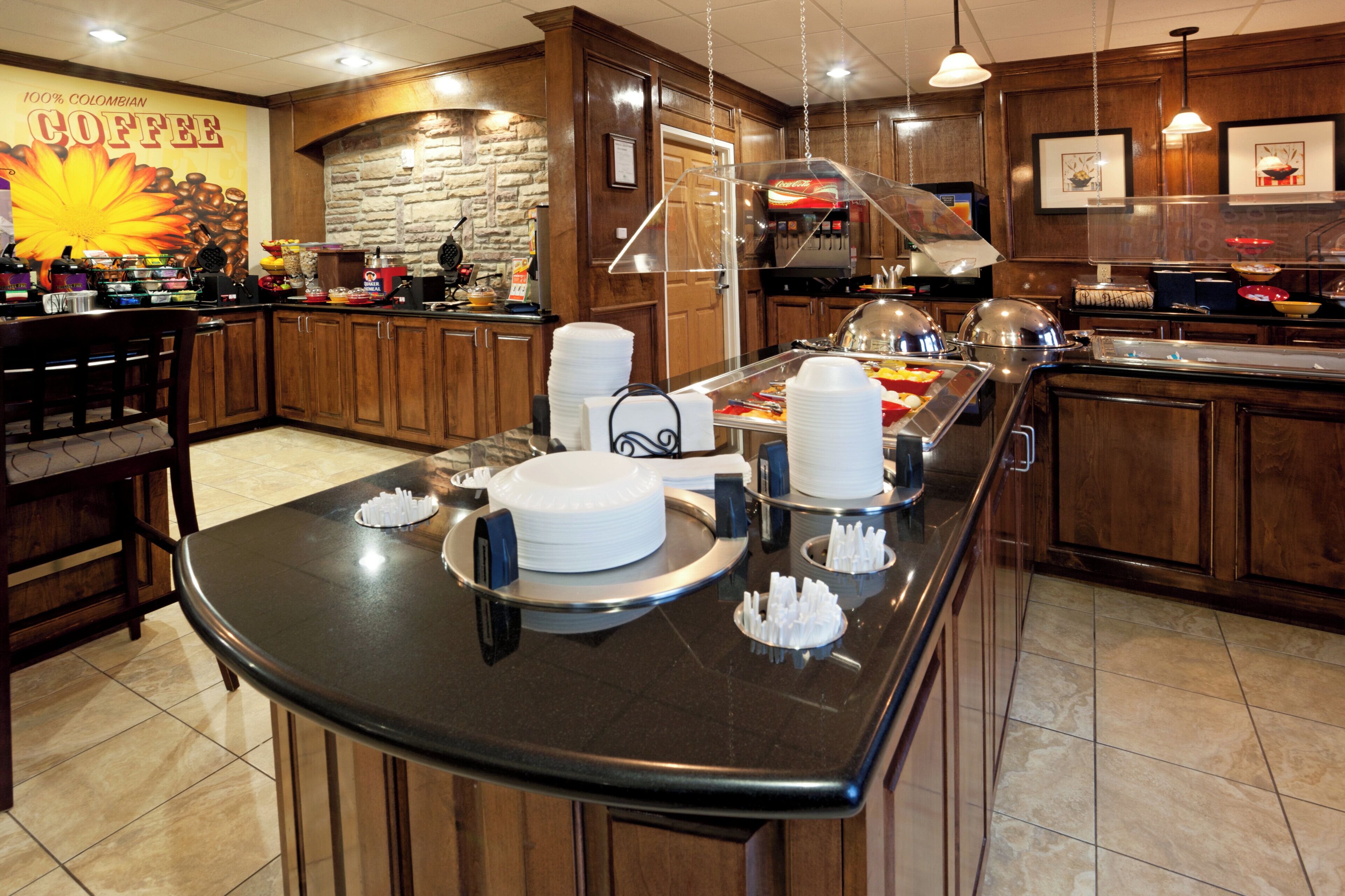 A buffet area with a variety of food items and a coffee station.