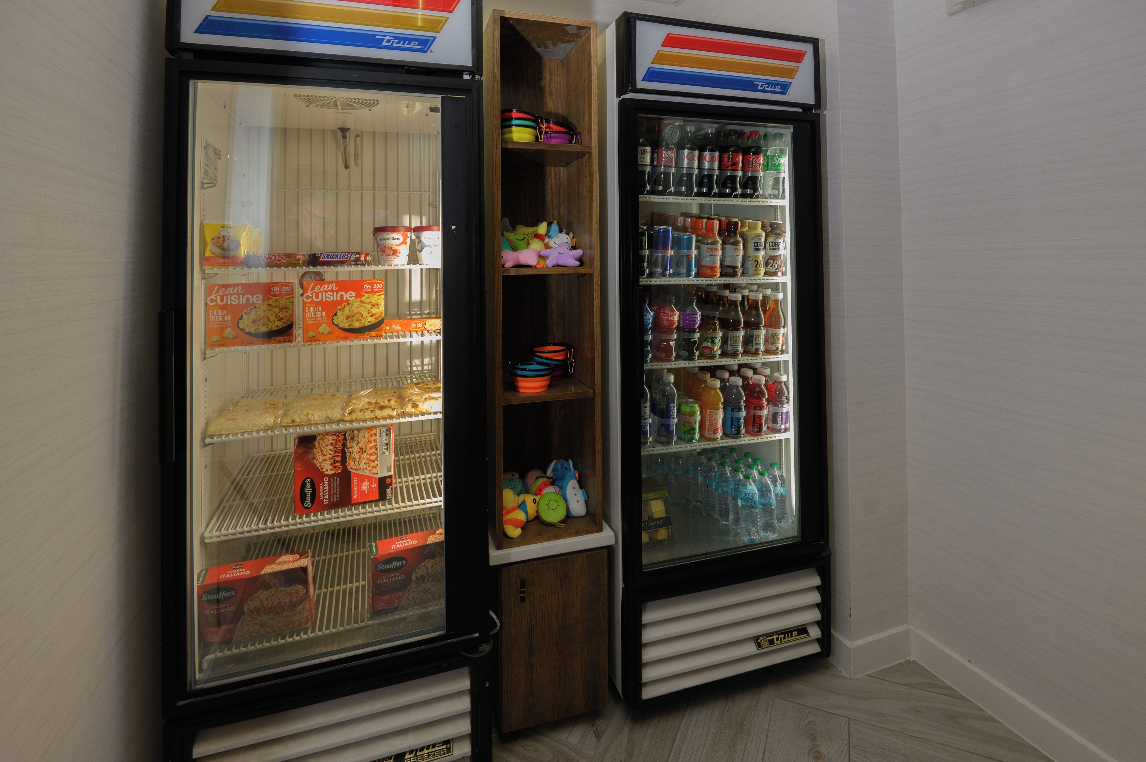 Three beverage dispensers with various drinks and snacks.