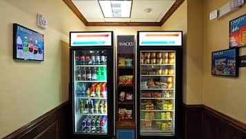 A vending area with drink and snack machines, including Coca-Cola and Planters Trail Mix.