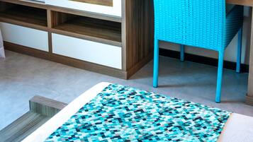 Relax in a stylish room with a large wardrobe, flat-screen TV, and comfortable seating area.