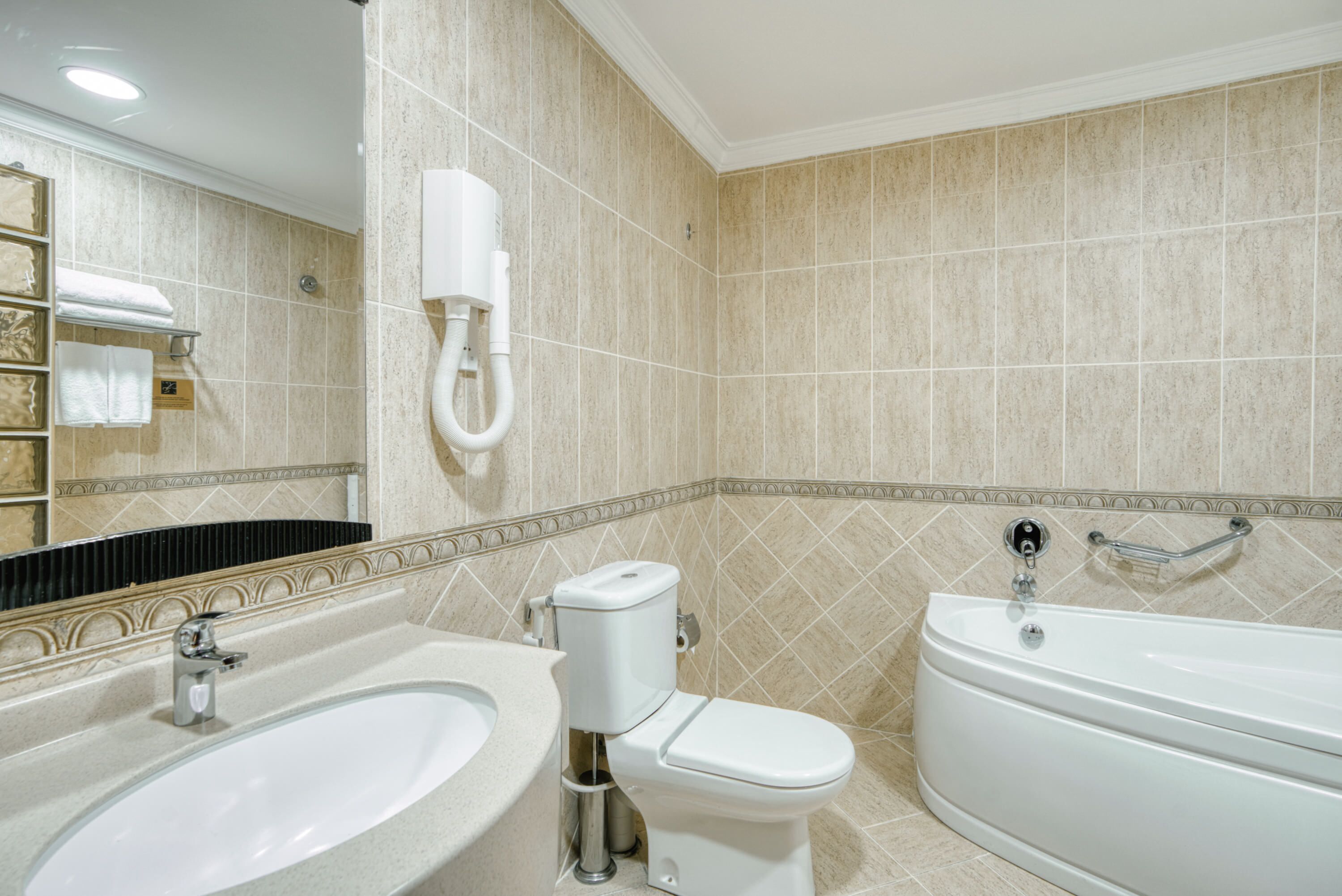 A bathroom with a sink, toilet, and bathtub.