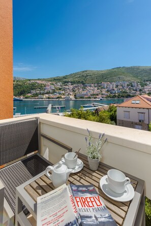 Enjoy a peaceful morning on this balcony overlooking the coastal town, where you can sit and read a book.