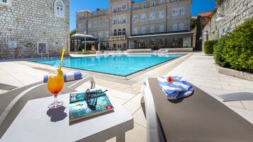 Piscina externa, guarda-sóis, espreguiçadeiras