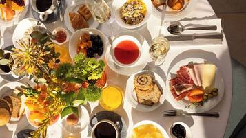 A breakfast buffet with various food items and beverages.