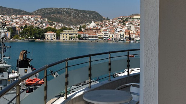 A balcony with a view of a harbor, boats, and a cityscape. - Blue Sea (Lesvos)