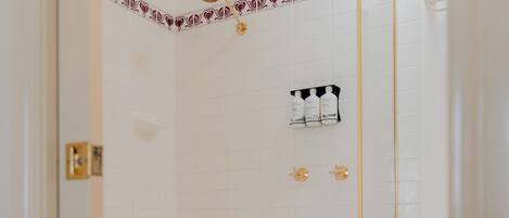 A modern bathroom with a freestanding bathtub, a shower enclosure, and a toilet.