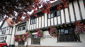 A traditional Tudor-style building with a sign reading "The Bull Long Melford."