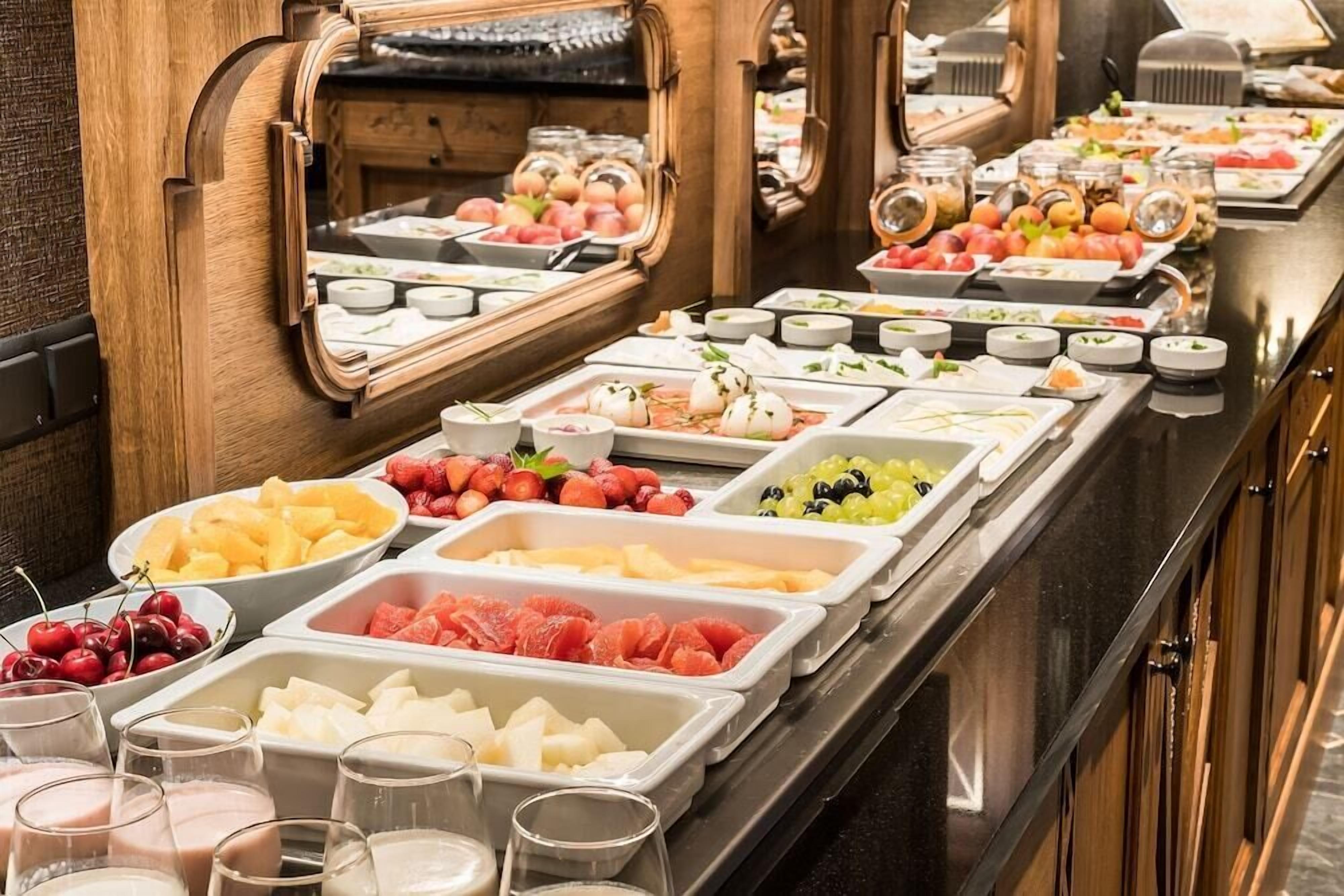 A buffet with various food items and beverages.