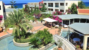 A resort with a pool, outdoor seating, and a view of the sea. - Hydramis Palace Beach Resort (Apokoronas)