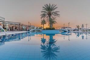 A swimming pool with palm trees and a glass bridge. - Hydramis Palace Beach Resort (Apokoronas)