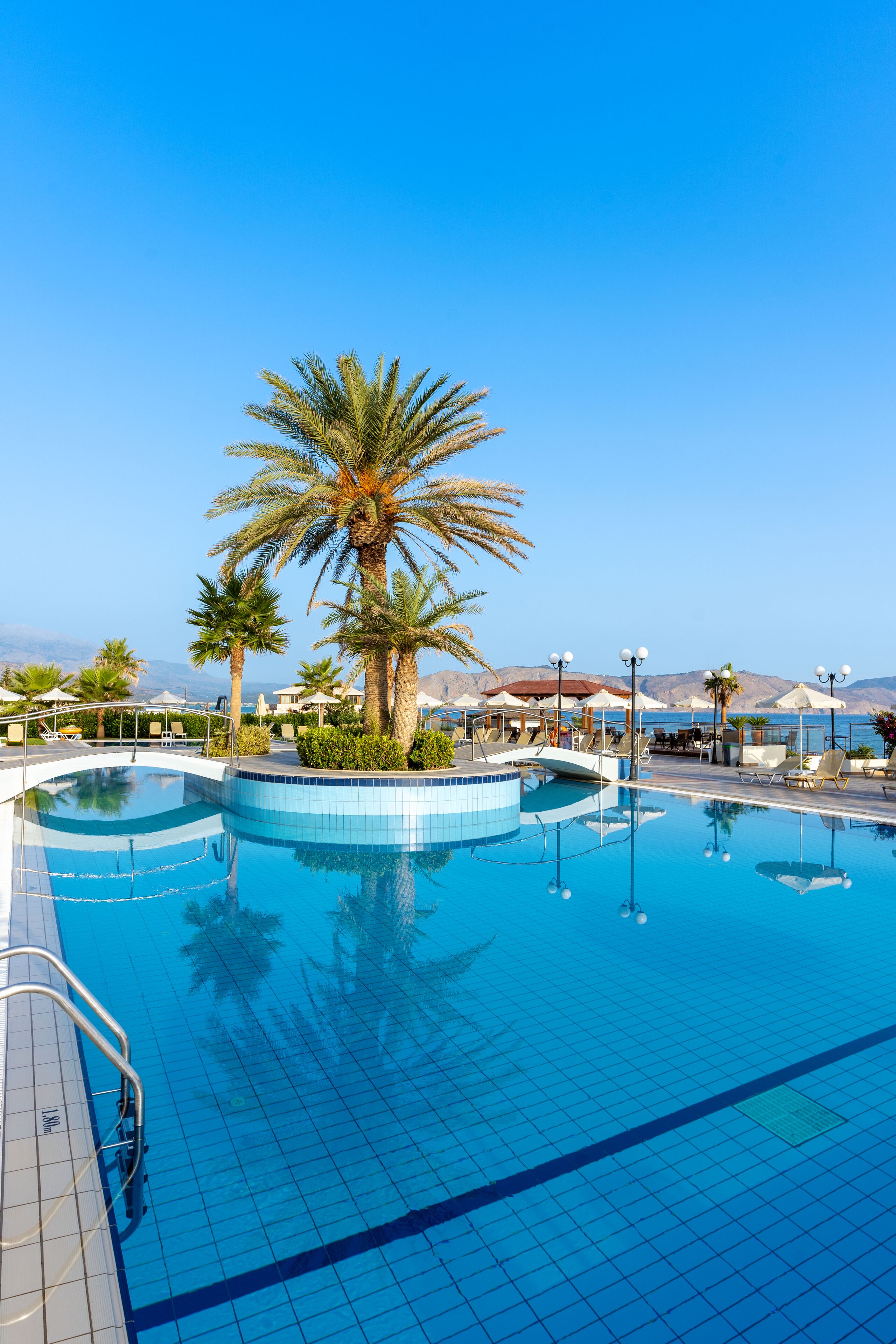 seasonal outdoor pool, pool umbrellas, pool loungers