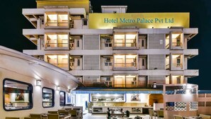 A multi-story hotel with a sign reading "Hotel Metro Palace Pvt Ltd." It features a dining area with tables and chairs, and a visible kitchen area. - Hotel Metro Palace (Mumbai)