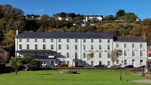 A large, multi-story hotel with a prominent entrance and a well-maintained lawn in front.