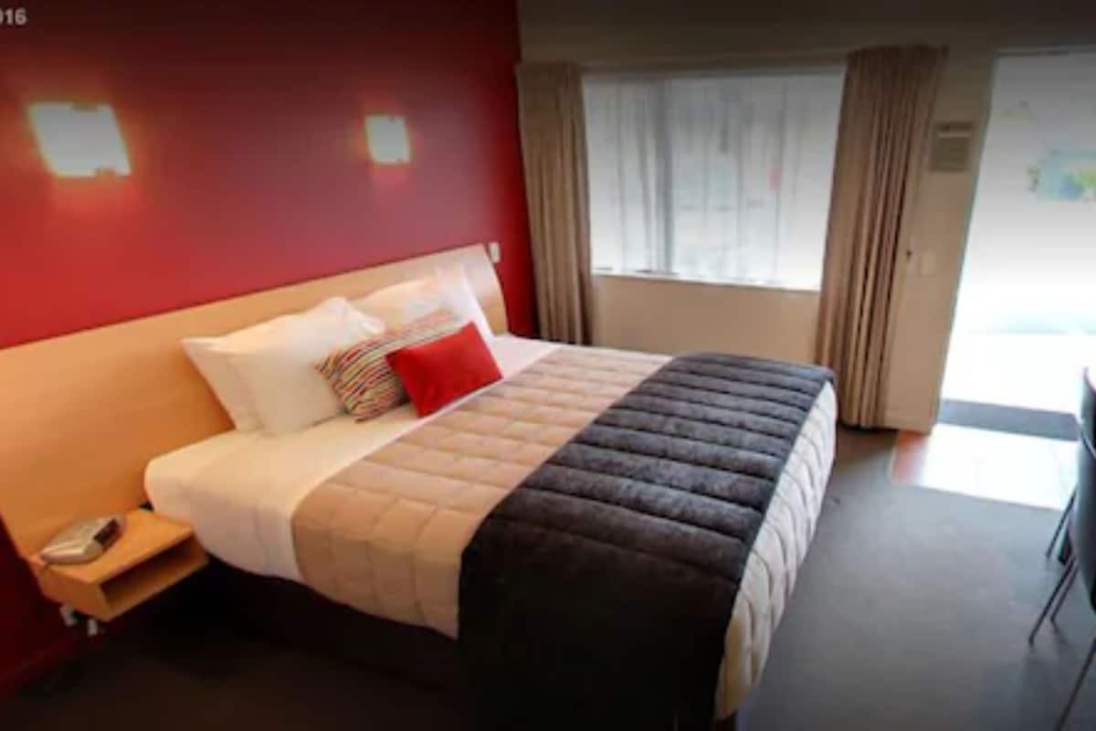accessible studio | premium bedding, desk, blackout curtains, soundproofing