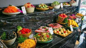 A buffet with various food items including salads, fruits, and cheeses. - Aurora Central Hotel  (Hanoi)