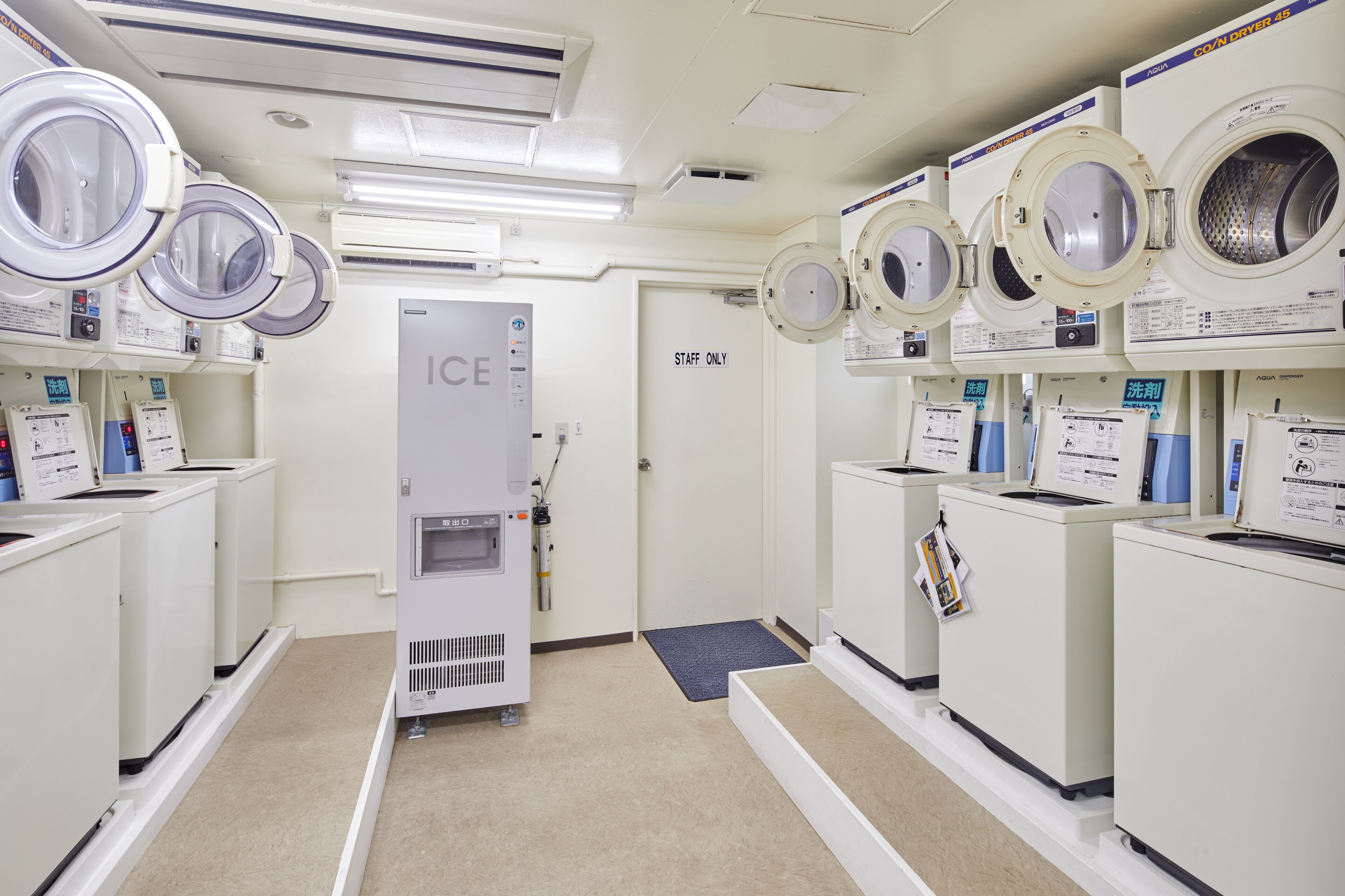 A laundry facility with multiple washing machines and an ice machine.