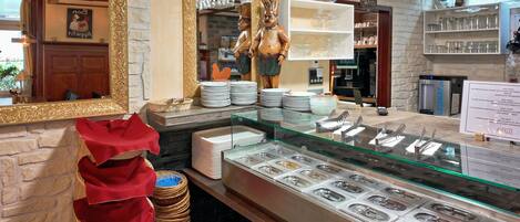 A buffet area with multiple food stations, a mirror, and a coffee station.