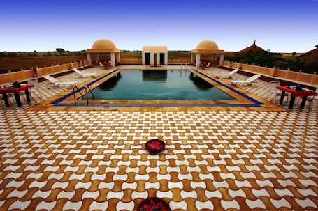 Outdoor pool, pool umbrellas. Mirvana Nature Resort and Camp