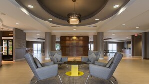 A spacious lobby with a central seating area, a reception desk, and a modern ceiling design. - SpringHill Suites by Marriott Columbia Downtown/The Vista (Columbia)