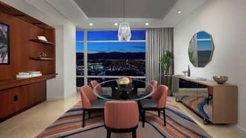 A modern dining room with a round glass table, six chairs, a large window with a city view, a wooden cabinet with shelves, and a decorative mirror.