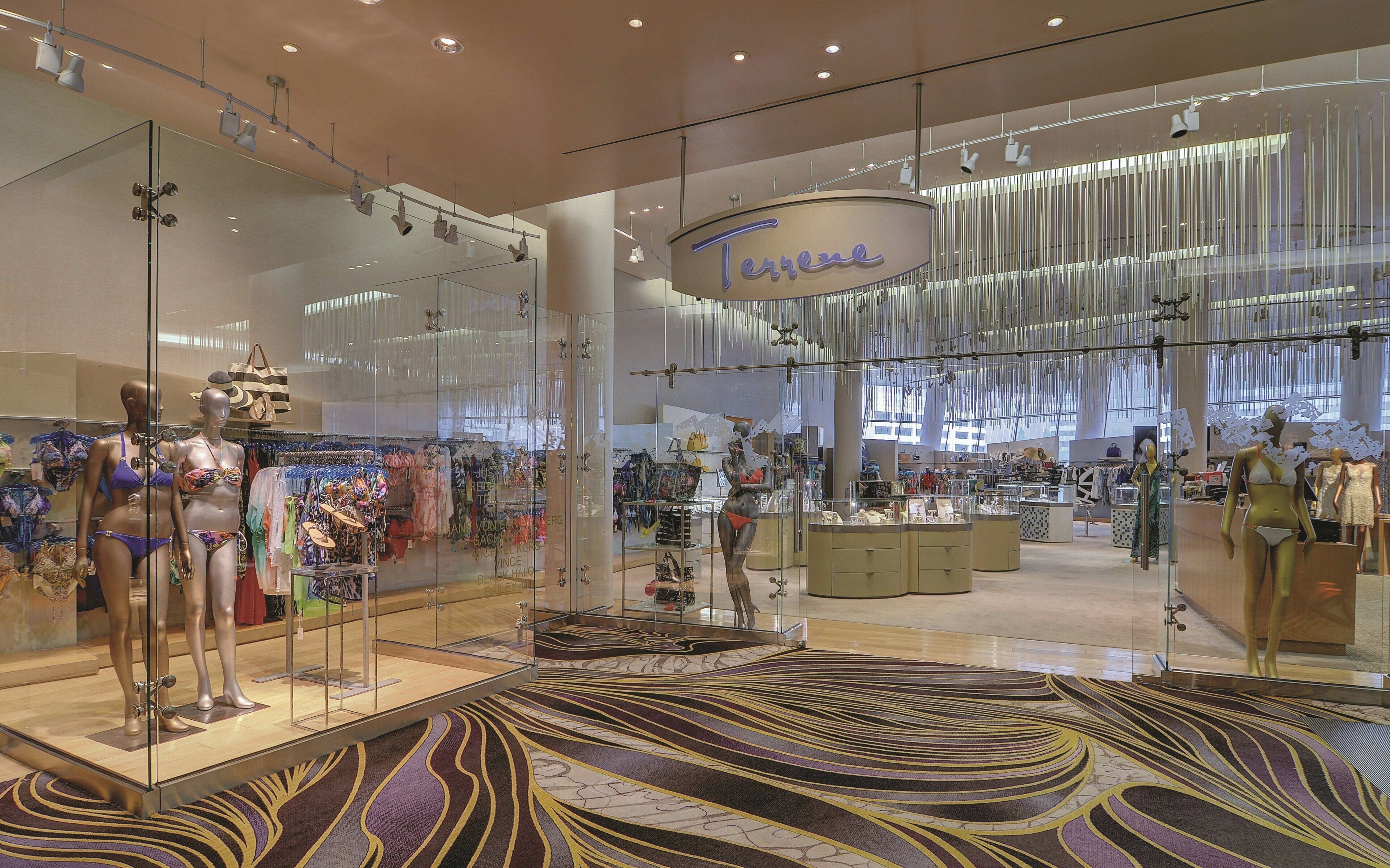A modern retail store with glass display cases and mannequins.