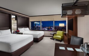 A hotel room with two beds, a desk, a chair, a TV, and a city view.