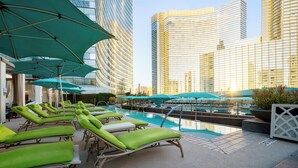 A rooftop pool area with sun loungers and umbrellas, surrounded by high-rise buildings. - Vdara Hotel & Spa at ARIA Las Vegas (Las Vegas)
