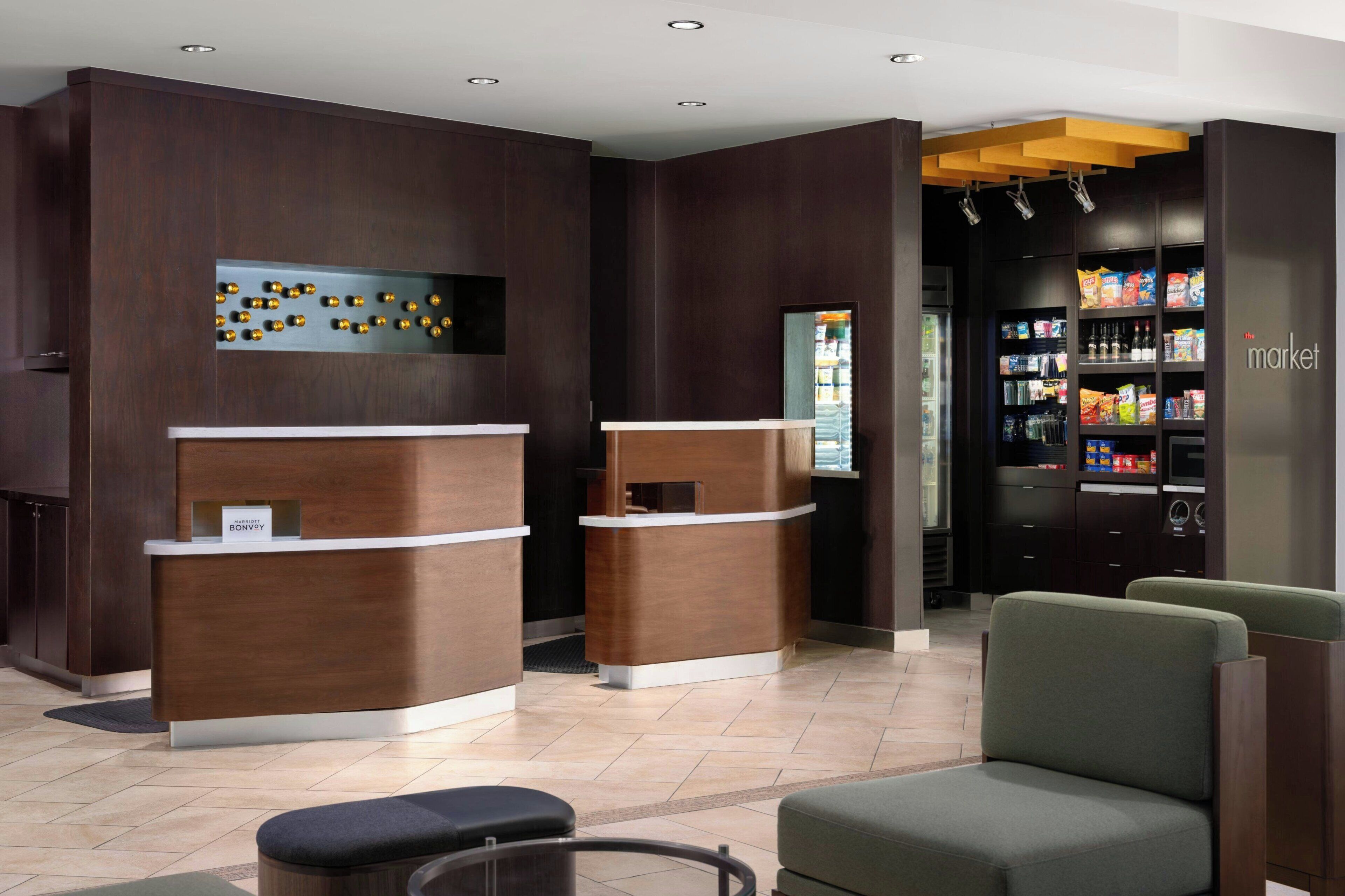 A reception area with two counters, a vending machine, and seating.