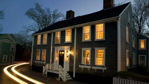 A two-story house with a porch and multiple windows, located at the end of a street. - Union Street Inn (Nantucket)