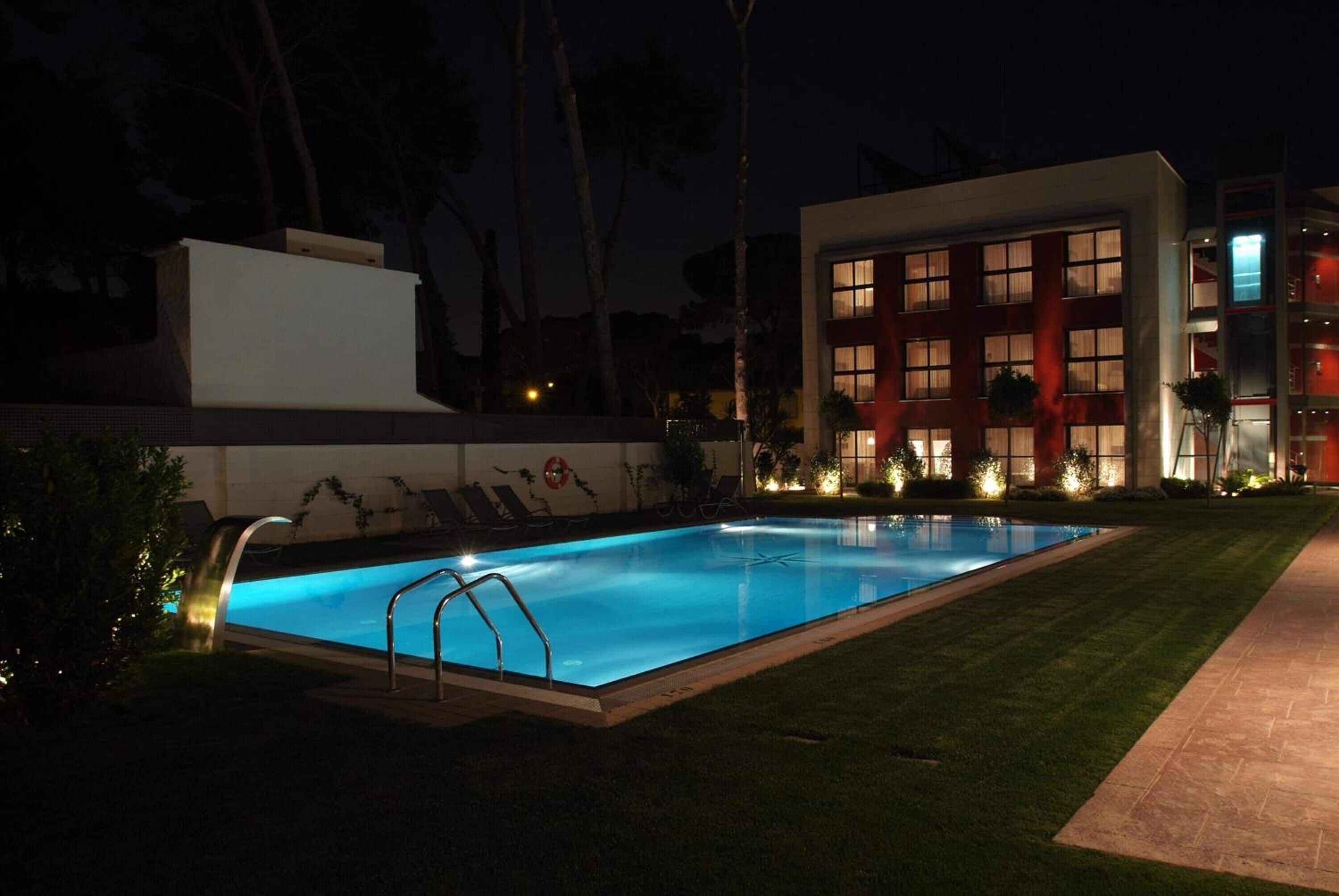A swimming pool with a modern building in the background.