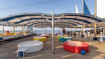 A deck with colorful seating, a bar, and a lifebuoy.