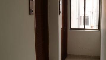 A hallway with two wooden doors, each marked with a number.