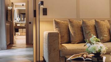 A modern living room with a sofa, a floor lamp, and a vase with flowers.