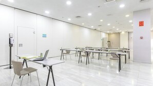 A conference room with white walls, numbered doors, and tables with chairs. - Hotel Sercotel JC1 Murcia (Murcia)