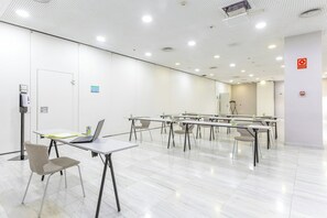 A conference room with white walls, numbered doors, and tables with chairs. - Hotel Sercotel JC1 Murcia (Murcia)