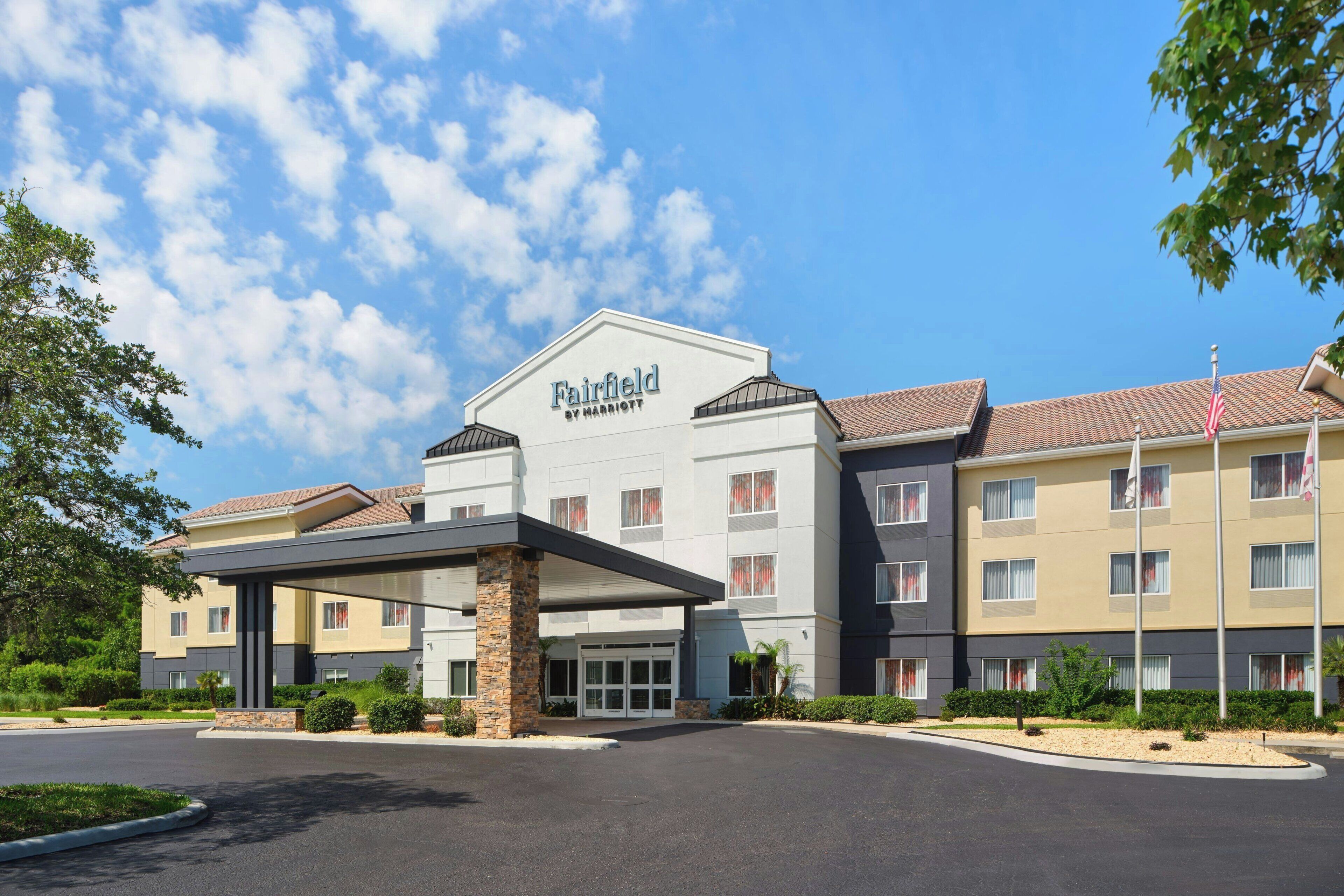 A Fairfield by Marriott hotel with a covered entrance, multiple buildings, and a clear sky.