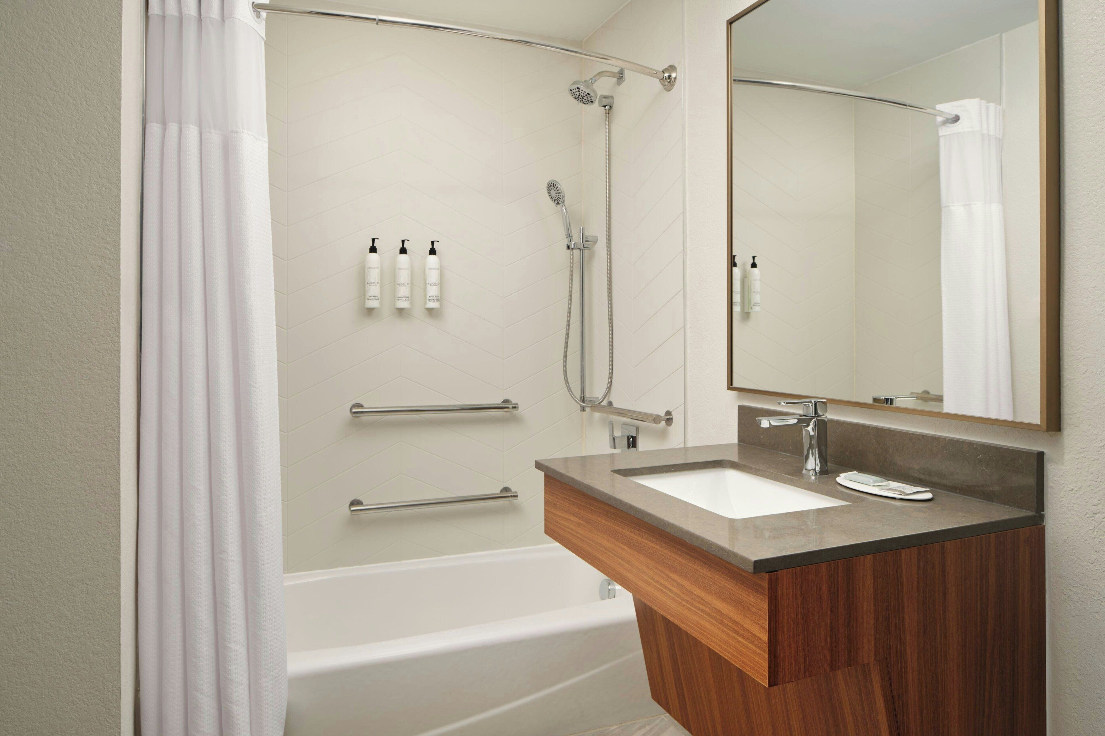 Un baño moderno con bañera, ducha e inodoro.