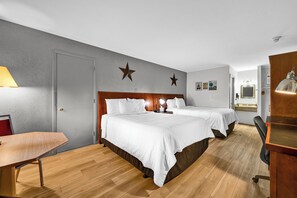 A hotel room with two beds, a desk, a chair, and a lamp. - Harvest Drive Family Inn (Gordonville)