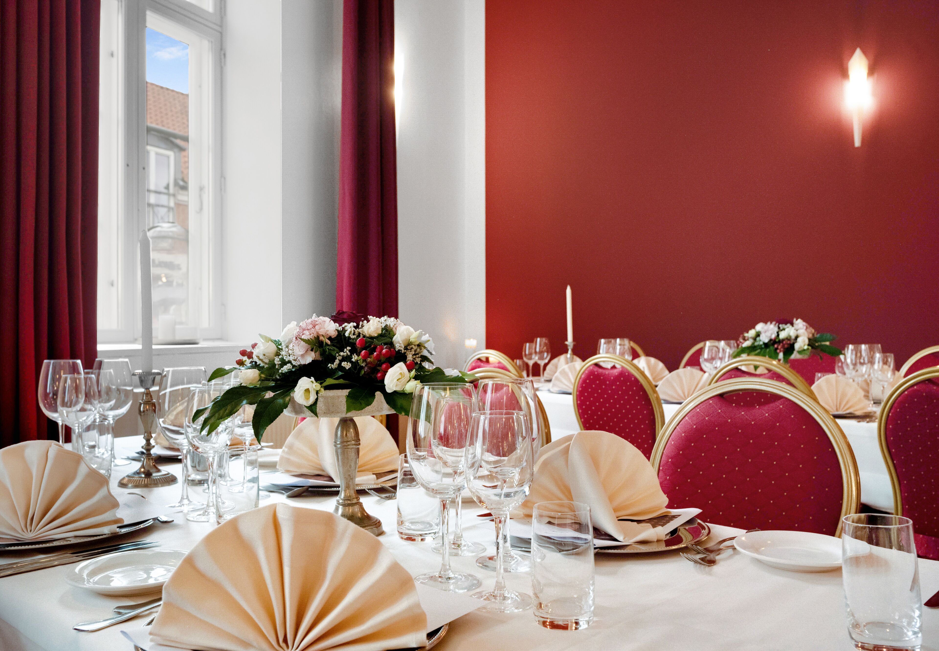 A dining table set with fine china, glassware, and elegant table settings.