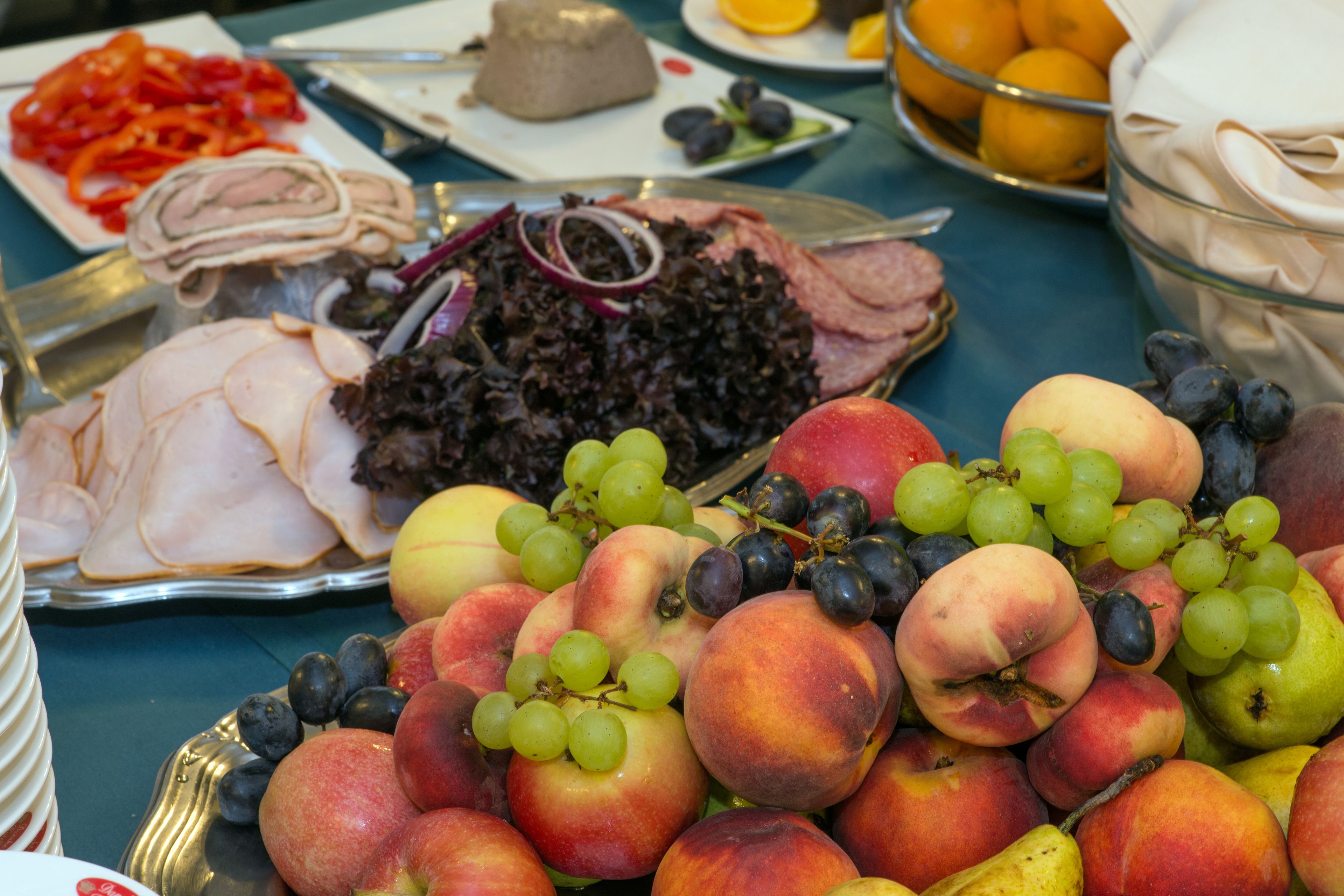 A table with various food items including fruits, vegetables, and meats.