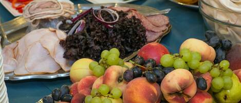A table with various food items including fruits, vegetables, and meats.