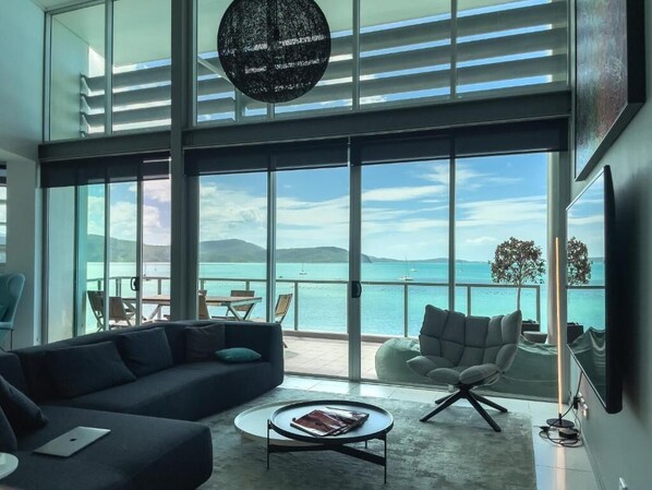 3 Bed 3 Bath Executive Deluxe Penthouse Apartment | Living area | Flat-screen TV, DVD player - Peninsula Airlie Beach (Cannonvale)