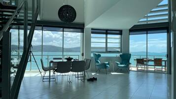 3 Bed 3 Bath Executive Deluxe Penthouse Apartment | Living area | Flat-screen TV, DVD player