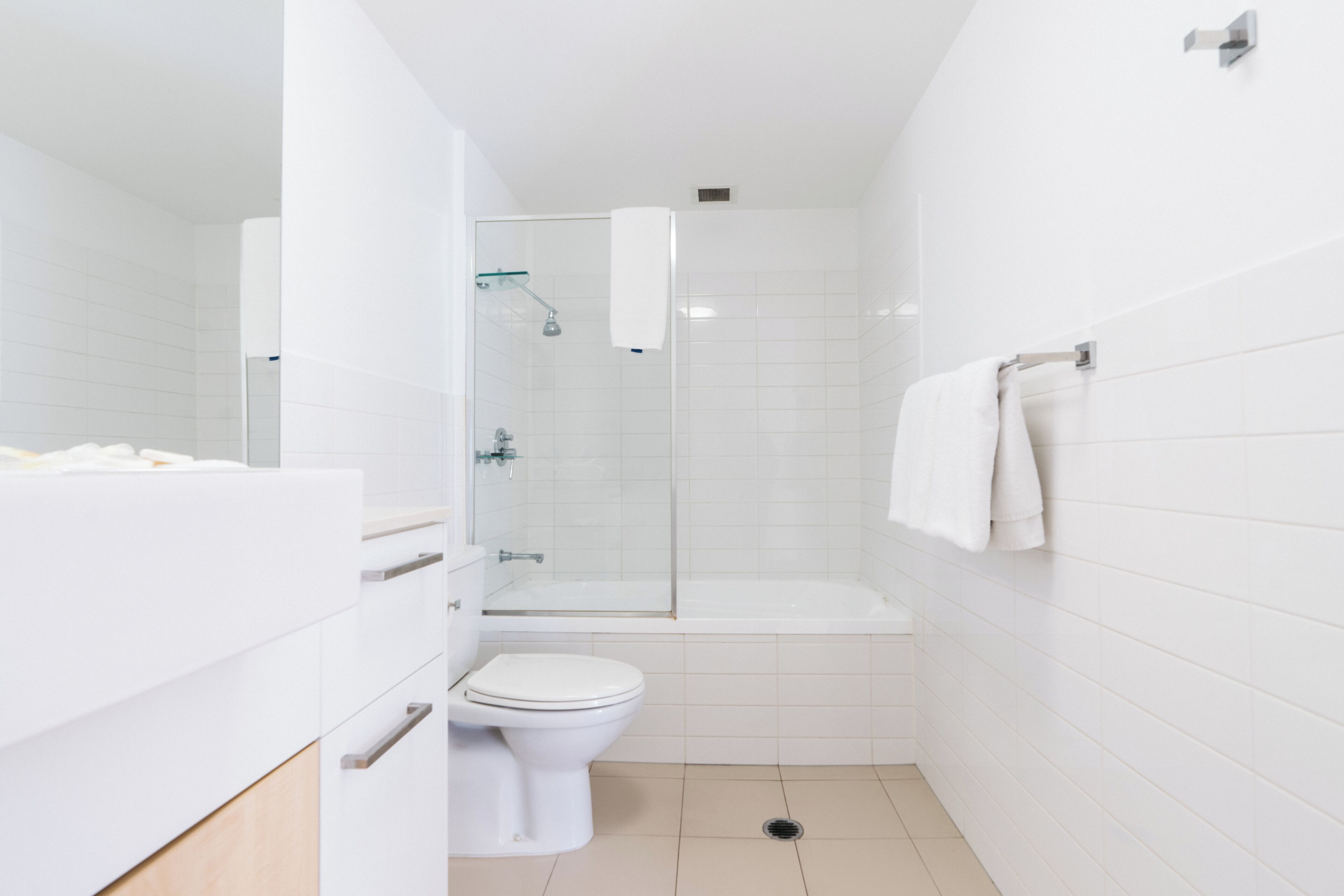 A modern bathroom with a toilet, shower, and bathtub.