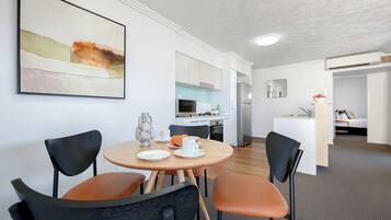 A modern kitchen with a refrigerator, microwave, and sink.